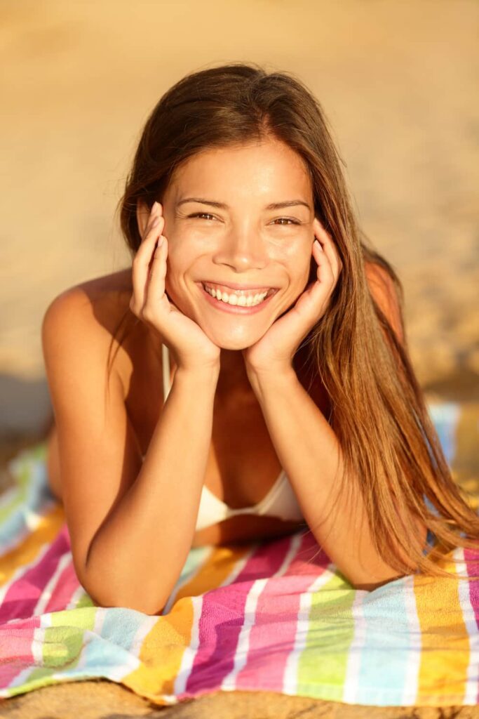 A happy young woman on the beach.