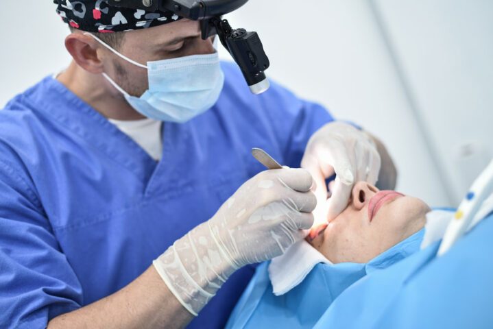 A doctor with a patient undergoing blepharoplasty
