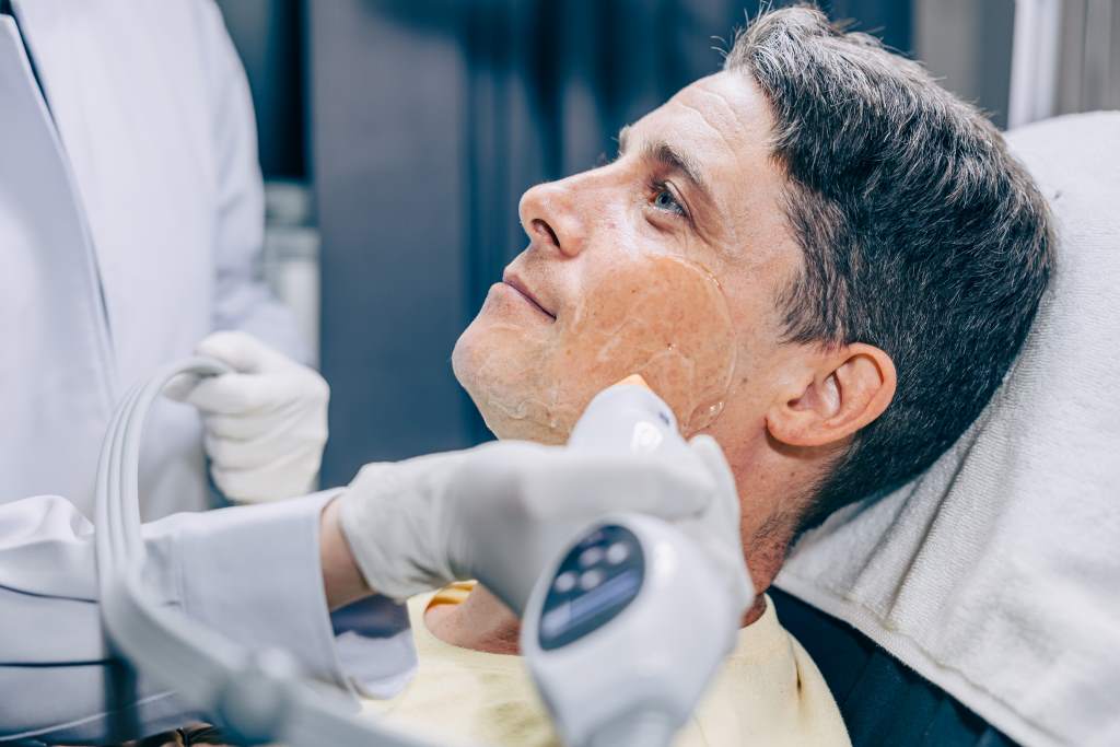 An older male getting laser anti-aging treatment in Bangkok