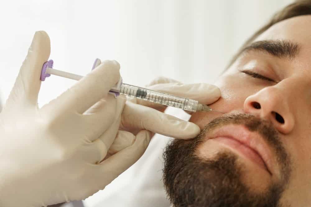 Male client having dermal filler injections