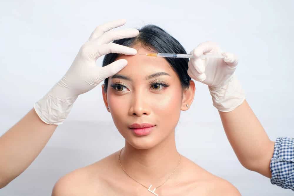  Asian woman undergoing Botox injections for skin tightening