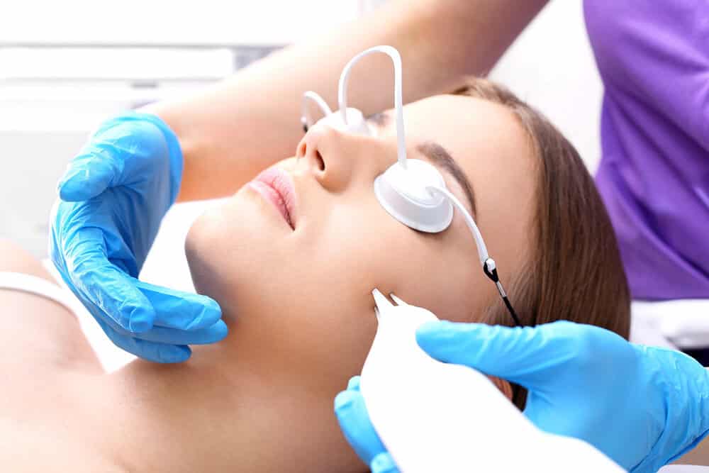 Woman receiving laser acne scar treatment