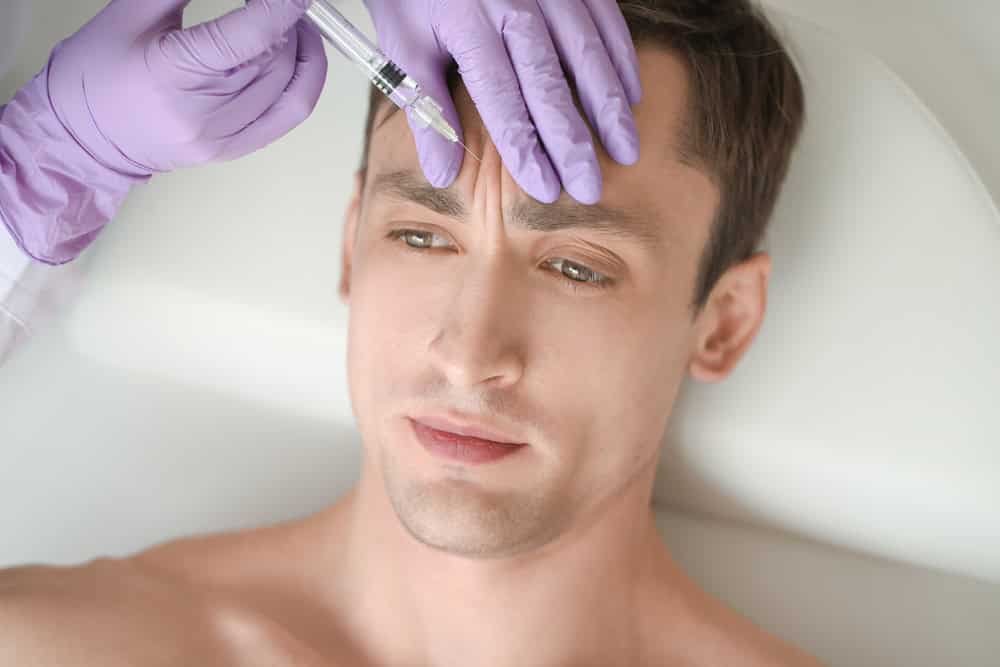 Someone having a filler as part of facial feminization treatment