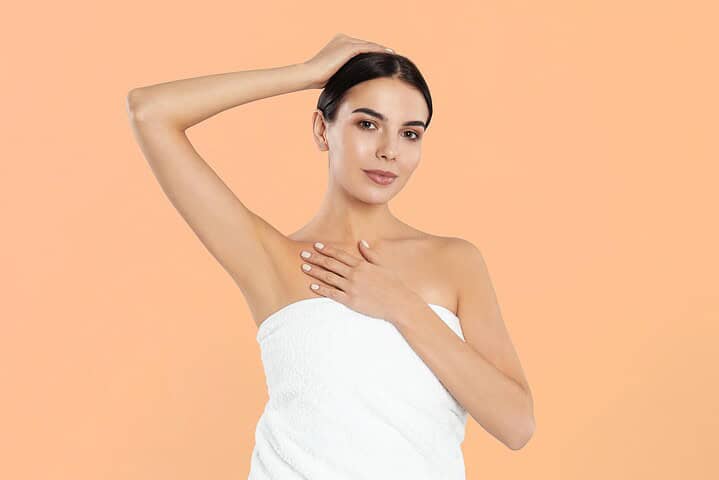 Woman showing hairless underarms
