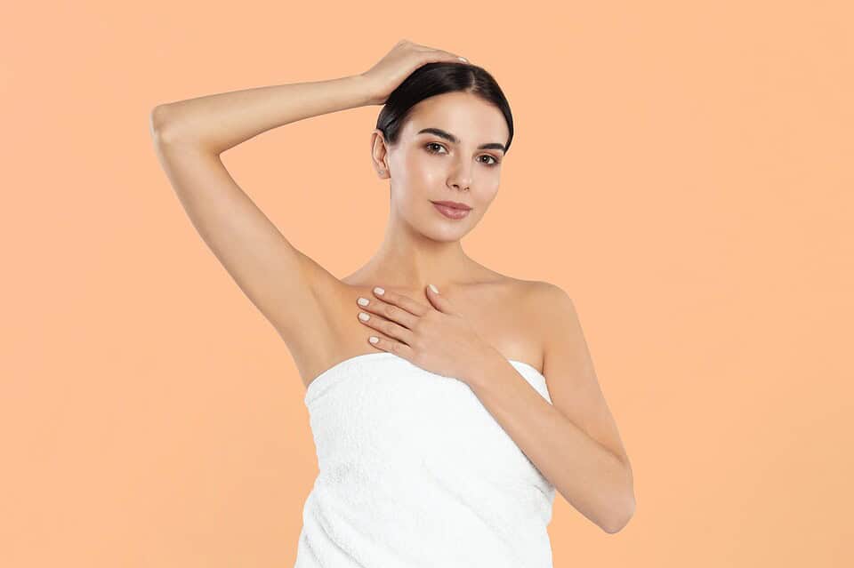 Woman showing hairless underarms