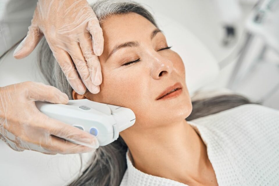 A woman receives laser skin tightening treatment