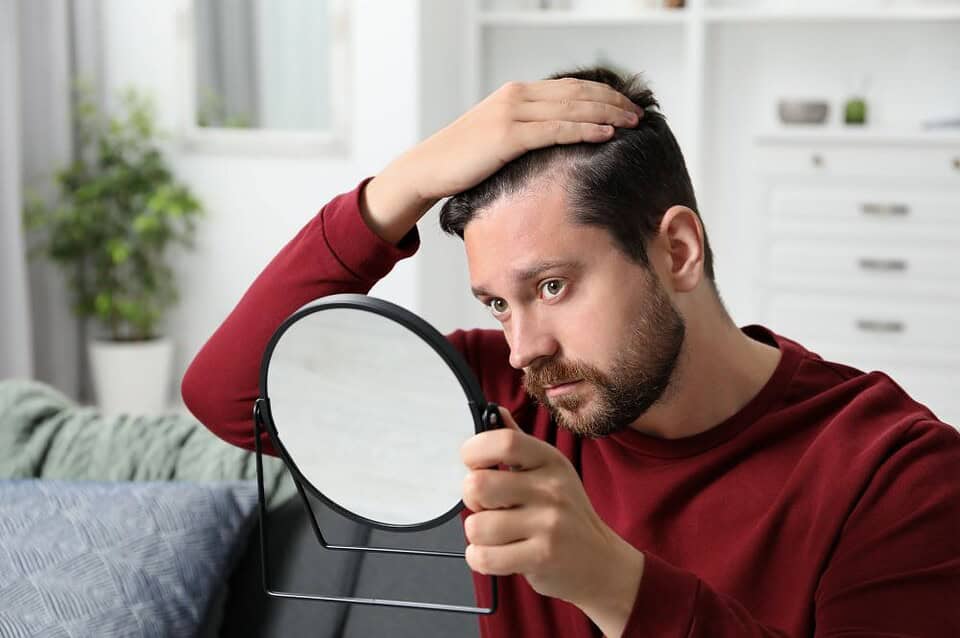 A man considers hair loss treatment