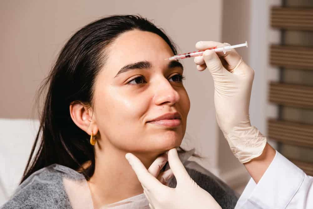 Patient consulting with a doctor to decide which is better, Botox or Dysport, for her face

