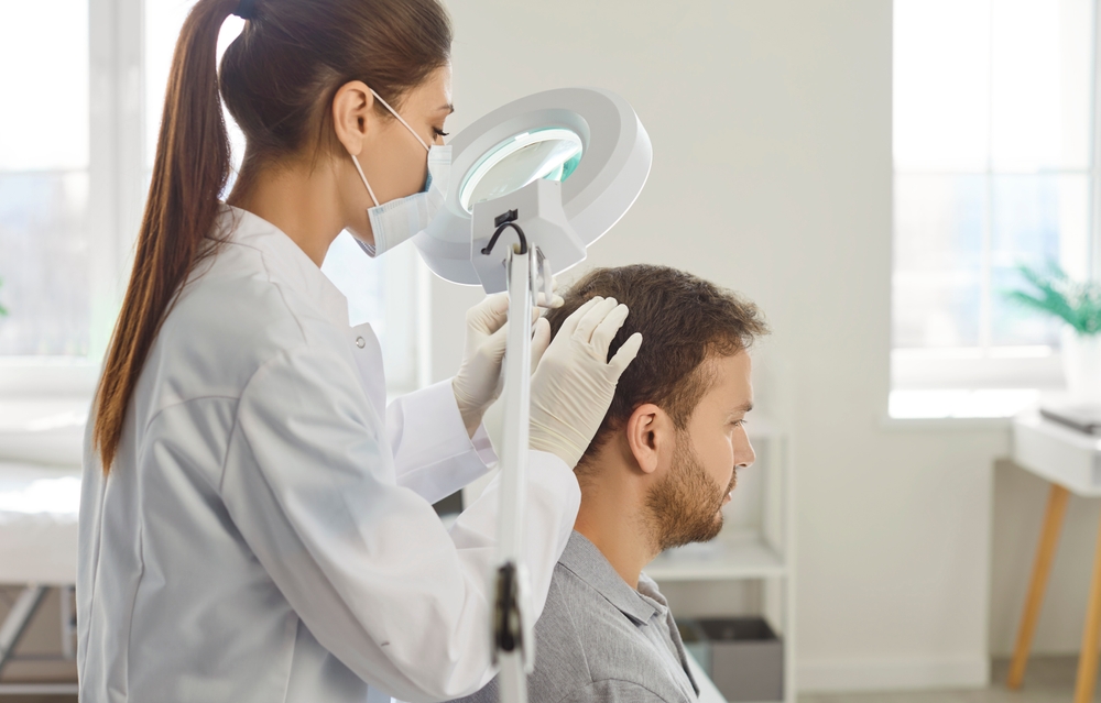 Doctor examining patient to plan a hair transplant for a receding hairline