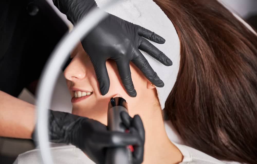 Practitioner performing a Potenza treatment for skin tightening on a patient's face

