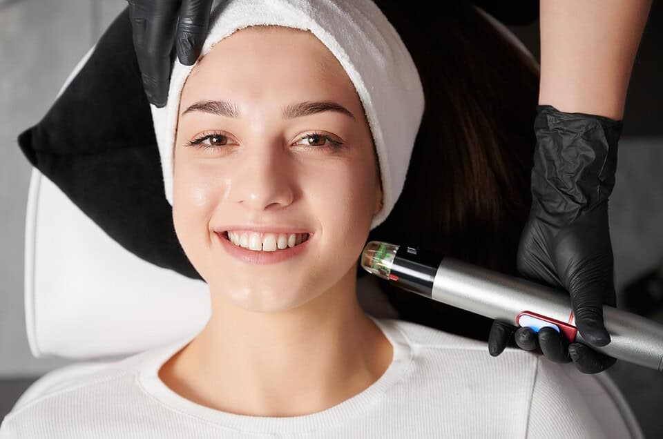 Patient undergoing Potenza microneedling on the lower face at an aesthetic clinic