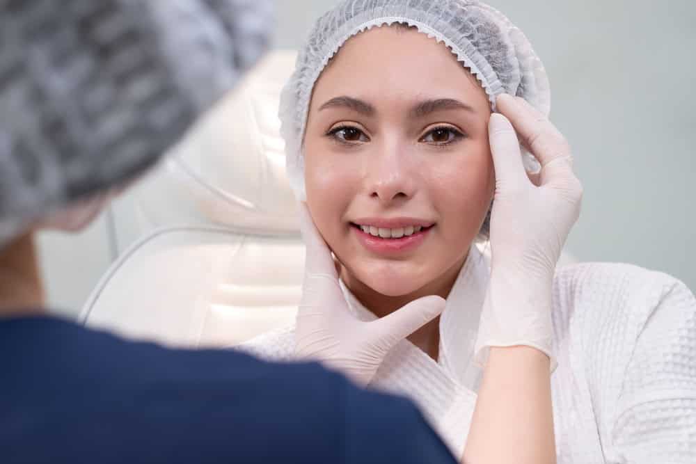 Woman consulting a doctor to decide between Juvelook vs Sculptra
