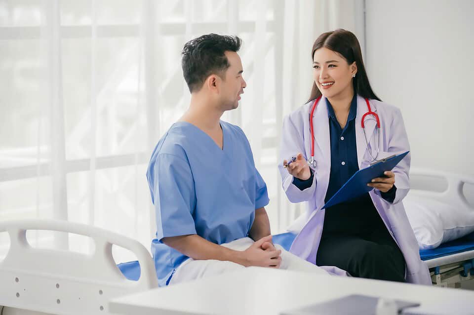 A transgender patient consulting with a plastic surgeon about FTM top surgery in Bangkok.