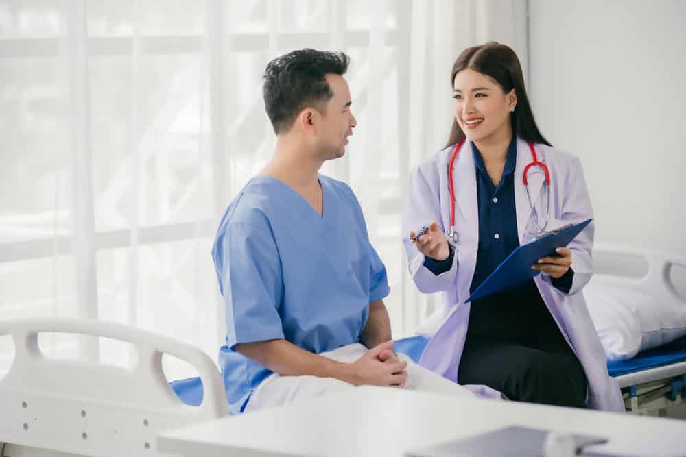 A transgender patient consulting with a plastic surgeon about FTM top surgery in Bangkok.