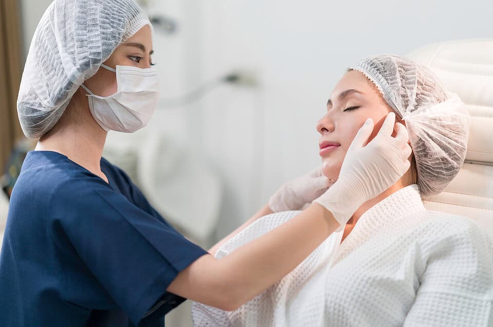 A surgeon in Bangkok preparing for a cosmetic surgery Thailand consultation with a patient.