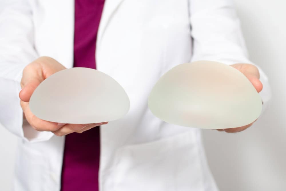 Selection of sizes of breast implants shown during a pre-surgery consultation in Bangkok.